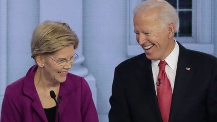 Elizabeth Warren and Joe Biden laugh during a debate.