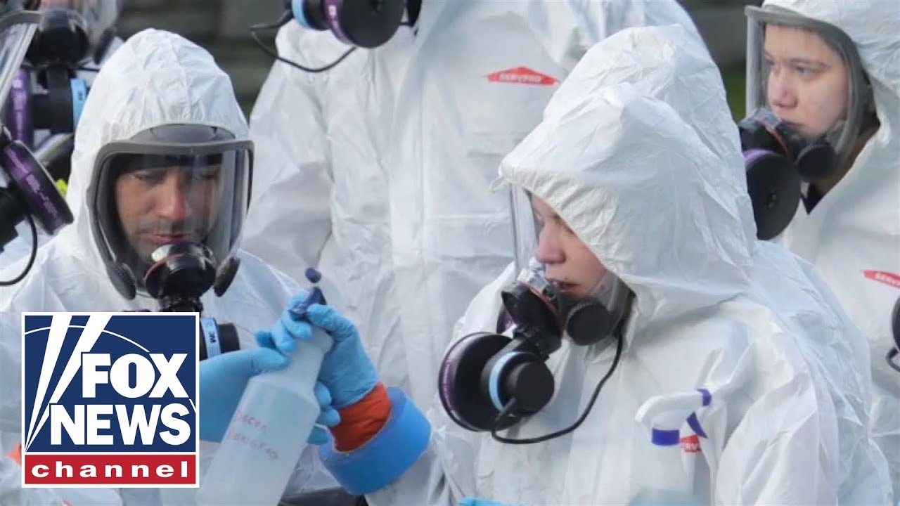 Still from Fox News showing medical professionals in hazmat suits.