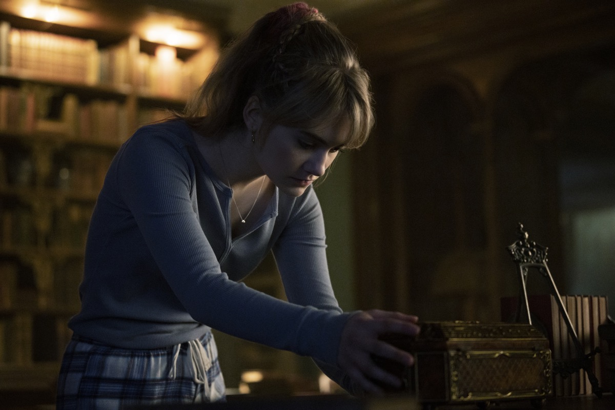 Kinsey peers into a box in Netflix's Locke and Key.