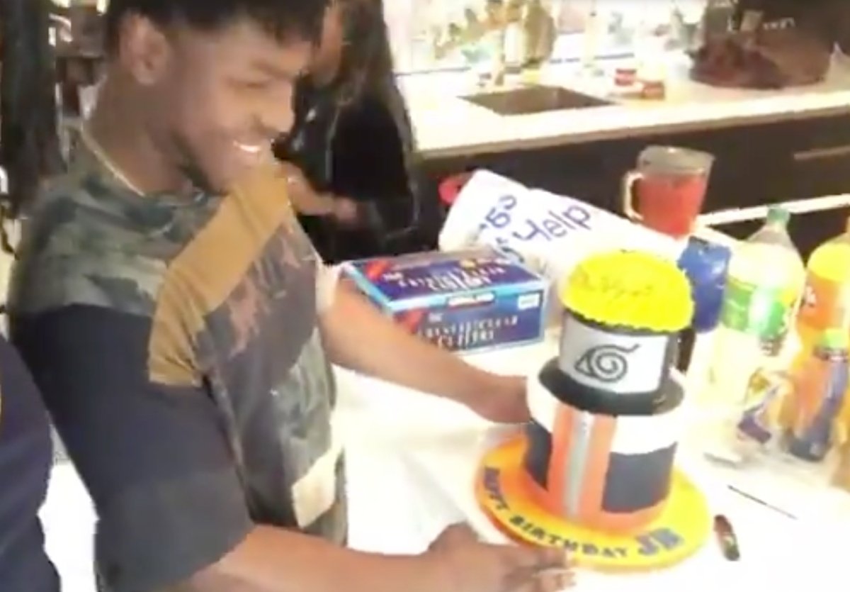 John Boyega, a Pisces icon, celebrating his birthday with naruto cake