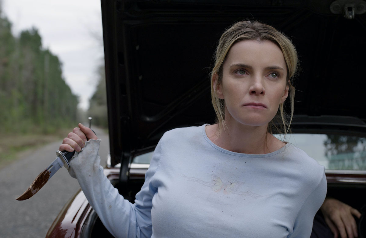 Betty Gilpin holds a bloody knife in a scene from The Hunt.
