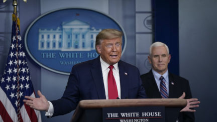 Donald Trump speaks as Vice President Mike Pence looks on during a briefing on the coronavirus pandemic in the press briefing room of the White House