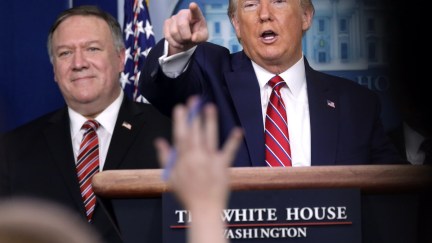 Donald Trump points at a reporter during a press briefing.