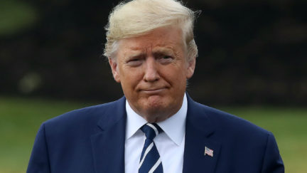 Donald Trump walks up to speak to the media before departing from the White House
