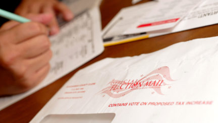 WILSONVILLE, OR - NOVEMBER 1: Jaime Valdez casts a ballot from his home November 1, 2004 in Wilsonville, Oregon. Oregon voters can now vote by mail instead of going to a polling station. (Photo by Craig Mitchelldyer/Getty Images)