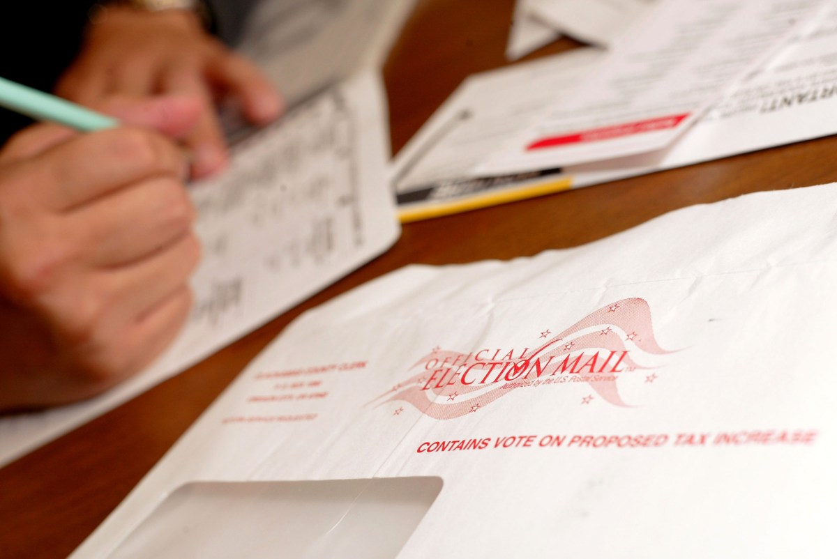 WILSONVILLE, OR - NOVEMBER 1: Jaime Valdez casts a ballot from his home November 1, 2004 in Wilsonville, Oregon. Oregon voters can now vote by mail instead of going to a polling station. (Photo by Craig Mitchelldyer/Getty Images)