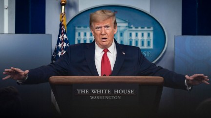 Donald Trump makes big arms during a coronavirus briefing.