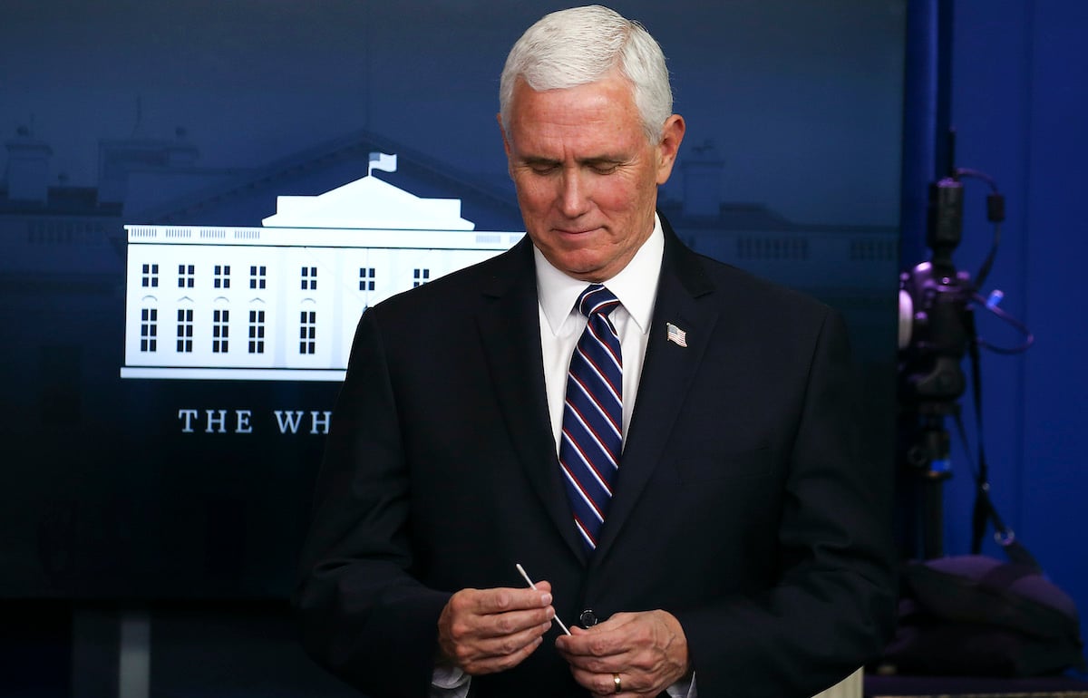Mike Pence holds up a swab at the daily coronavirus briefing at the White House