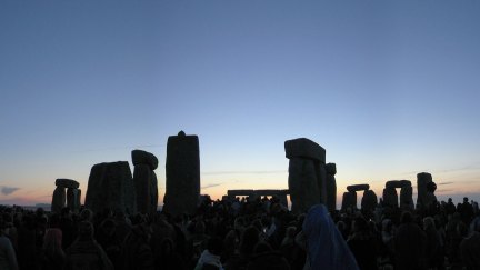 pagans gather before stonehenge on the summer solstice