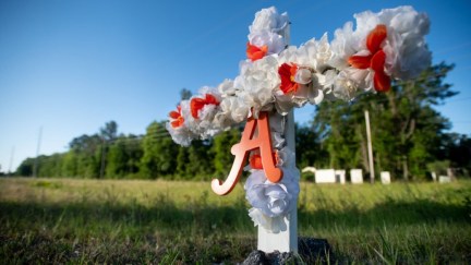 BRUNSWICK, GA - MAY 07: A cross with flowers and a letter A sits at the entrance to the Satilla Shores neighborhood where Ahmaud Arbery was shot and killed May 7, 2020 in Brunswick, Georgia. Arbery was shot during a confrontation with an armed father and son on Feb 23. (Photo by Sean Rayford/Getty Images)