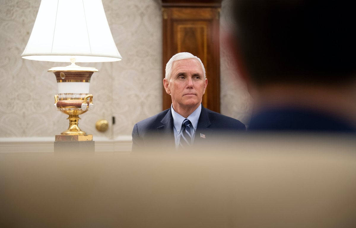 Mike Pence sits in the Oval Office without a face mask.
