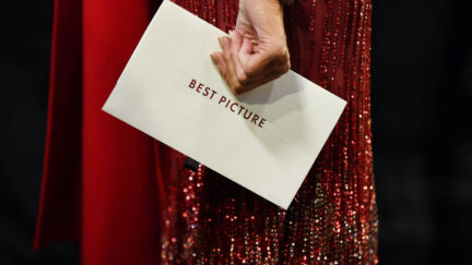A woman's hand holds the Best Picture envelope