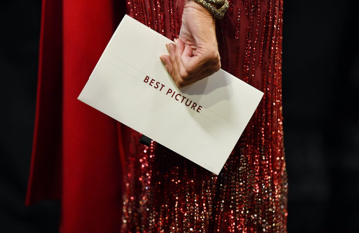 A woman's hand holds the Best Picture envelope