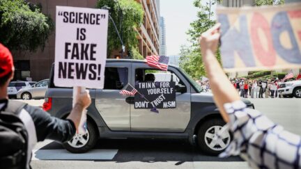 Demonstrators protest during a rally to re-open California