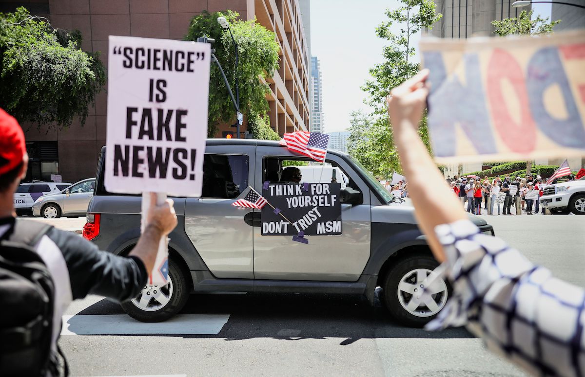 Demonstrators protest during a rally to re-open California
