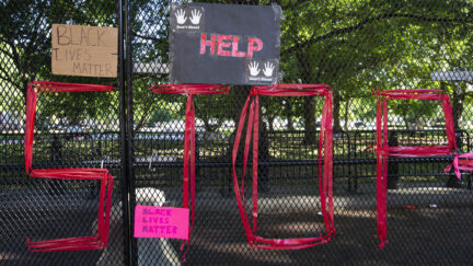 Signs are left in front of the White House's recently erected security fence now turned into a memorial against police brutality and the death of George Floyd, during a peaceful protest on June 7, 2020 in Washington, DC. - On May 25, 2020, Floyd, a 46-year-old black man suspected of passing a counterfeit $20 bill, died in Minneapolis after Derek Chauvin, a white police officer, pressed his knee to Floyd's neck for almost nine minutes. (Photo by Jose Luis Magana / AFP) (Photo by JOSE LUIS MAGANA/AFP via Getty Images)