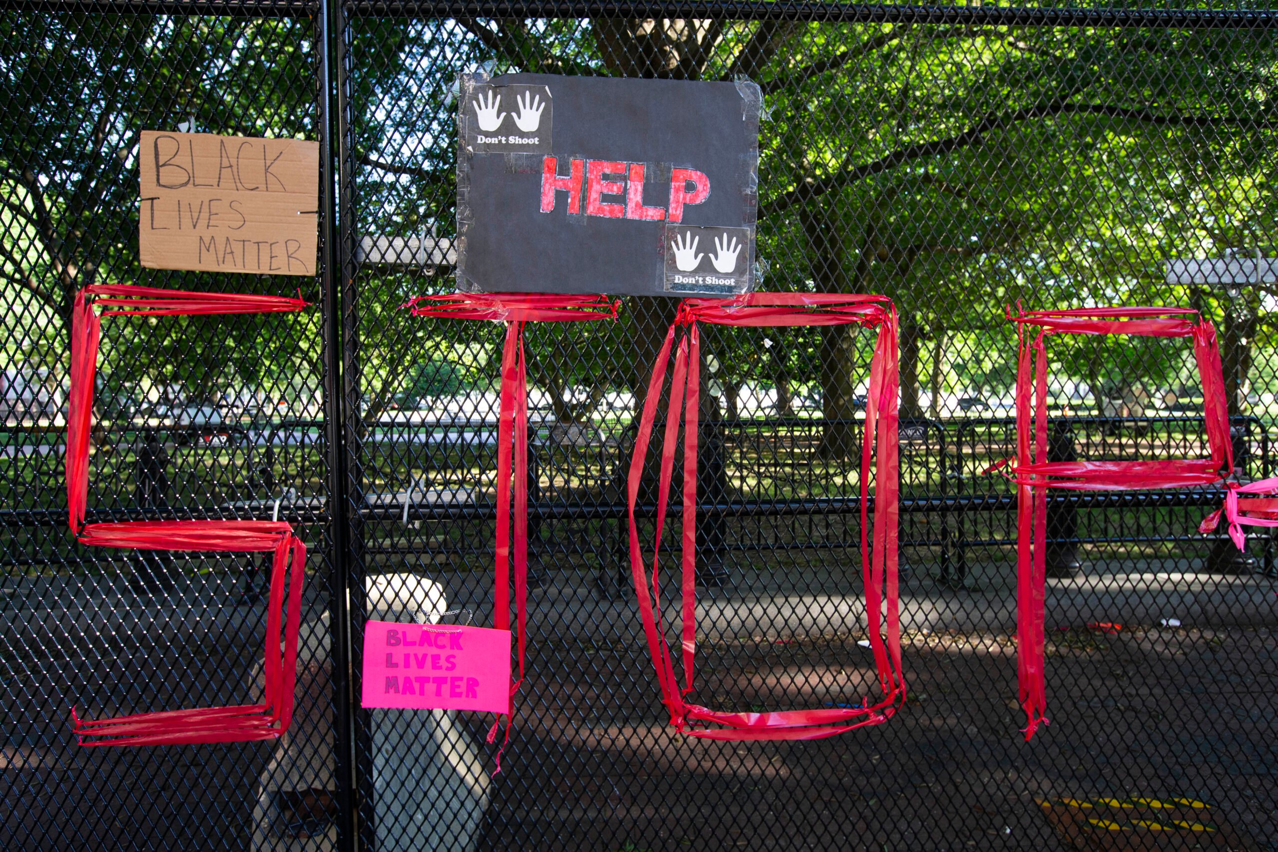 Signs are left in front of the White House's recently erected security fence now turned into a memorial against police brutality and the death of George Floyd, during a peaceful protest on June 7, 2020 in Washington, DC. - On May 25, 2020, Floyd, a 46-year-old black man suspected of passing a counterfeit $20 bill, died in Minneapolis after Derek Chauvin, a white police officer, pressed his knee to Floyd's neck for almost nine minutes. (Photo by Jose Luis Magana / AFP) (Photo by JOSE LUIS MAGANA/AFP via Getty Images)