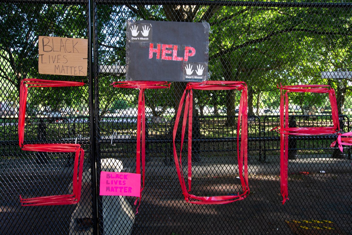 Signs are left in front of the White House's recently erected security fence now turned into a memorial against police brutality and the death of George Floyd, during a peaceful protest on June 7, 2020 in Washington, DC. - On May 25, 2020, Floyd, a 46-year-old black man suspected of passing a counterfeit $20 bill, died in Minneapolis after Derek Chauvin, a white police officer, pressed his knee to Floyd's neck for almost nine minutes. (Photo by Jose Luis Magana / AFP) (Photo by JOSE LUIS MAGANA/AFP via Getty Images)