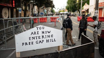 SEATTLE, WA - JUNE 10: A sign is seen on a barrier at an entrance to the so-called 
