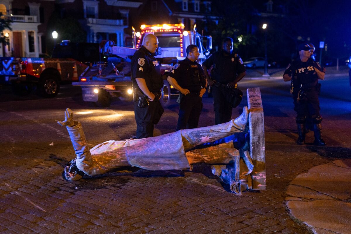 A statue of Confederate States President Jefferson Davis lies on the street after protesters pulled it down in Richmond, Virginia, on June 10, 2020. - The symbols of the Confederate States and its support for slavery are being targeted for removal following the May 25, 2020, death of George Floyd while in police custody. (Photo by Parker Michels-Boyce / AFP) (Photo by PARKER MICHELS-BOYCE/AFP via Getty Images)