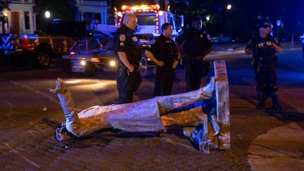 A statue of Confederate States President Jefferson Davis lies on the street after protesters pulled it down in Richmond, Virginia, on June 10, 2020. - The symbols of the Confederate States and its support for slavery are being targeted for removal following the May 25, 2020, death of George Floyd while in police custody. (Photo by Parker Michels-Boyce / AFP) (Photo by PARKER MICHELS-BOYCE/AFP via Getty Images)