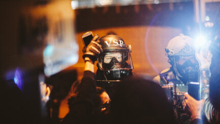 RICHMOND, VA - JUNE 14: Police look on as protesters surround the police head quarters to protest against police brutality, the killing of George Floyd and were calling for the firing of the police officers involved in the hit-and-run of several protesters the night before, on June 14, 2020 in Richmond, United States. George Floyd died on May 25th when he was in Minneapolis police custody, sparking nationwide protests. A white police officer, Derek Chauvin, has been charged with second-degree murder, with the three other officers involved facing other charges. (Photo by Eze Amos/Getty Images)