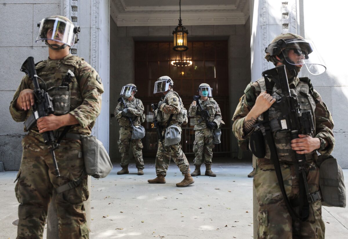 LOS ANGELES, CALIFORNIA - JUNE 03: National Guard troops are posted outside the District Attorney's office during a peaceful demonstration over George Floyd’s death on June 3, 2020 in Los Angeles, California. California Governor Gavin Newsom deployed National Guard troops to Los Angeles County following unrest which occurred amid some demonstrations. Former Minneapolis police officer Derek Chauvin was taken into custody for Floyd's death and is now charged with second-degree murder while three other former officers have been charged with aiding and abetting second-degree murder. (Photo by Mario Tama/Getty Images)