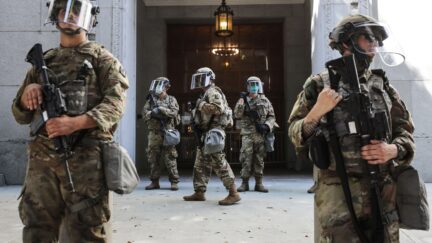 LOS ANGELES, CALIFORNIA - JUNE 03: National Guard troops are posted outside the District Attorney's office during a peaceful demonstration over George Floyd’s death on June 3, 2020 in Los Angeles, California. California Governor Gavin Newsom deployed National Guard troops to Los Angeles County following unrest which occurred amid some demonstrations. Former Minneapolis police officer Derek Chauvin was taken into custody for Floyd's death and is now charged with second-degree murder while three other former officers have been charged with aiding and abetting second-degree murder. (Photo by Mario Tama/Getty Images)