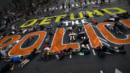 Demonstrators lie on the pavement during a peaceful protest against police brutality and racism