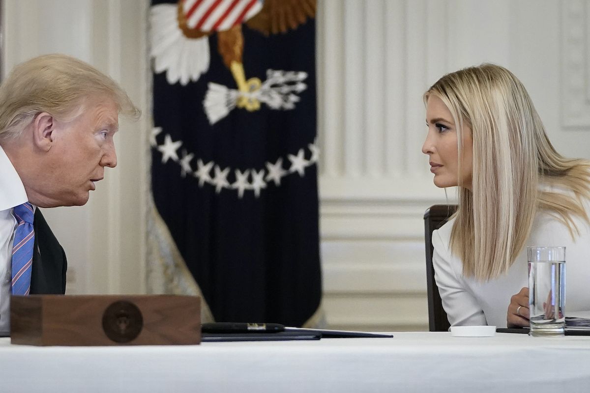 Ivanka and Donald Trump lean in to talk.