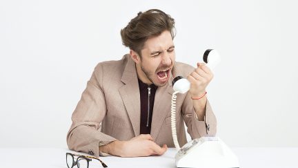 man yelling into phone