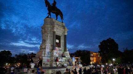 People gather around the Robert E. Lee statue on Monument Avenue in Richmond, Virginia