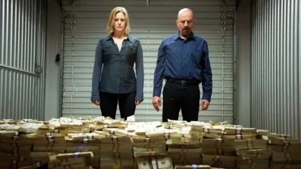 Skyler and Walter White staring at a massive pile of money in a storage unit on AMC's Breaking Bad.