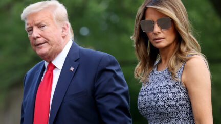 Donald and Melania Trump walk outside.