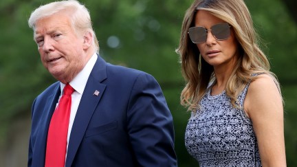 Donald and Melania Trump walk outside.