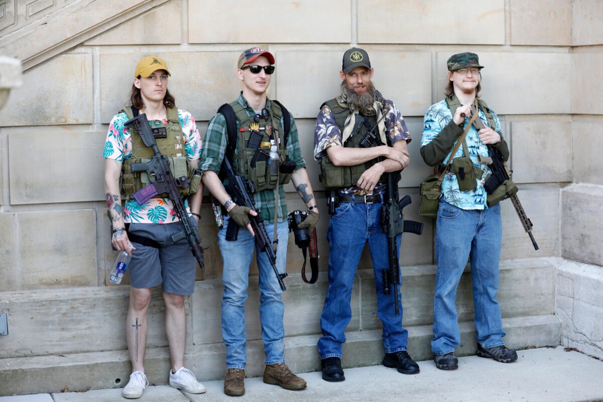 Armed protesters demonstrate during the Michigan Conservative Coalition organized "Operation Haircut" outside the Michigan State Capitol in Lansing, Michigan on May 20, 2020. - The group is protesting Michigan Governor Gretchen Whitmer's mandatory closure to curtail the coronavirus pandemic. The Hawaiian shirts are a kind of uniform for members of extremist groups "Boogaloo". (Photo by JEFF KOWALSKY / AFP) (Photo by JEFF KOWALSKY/AFP via Getty Images)