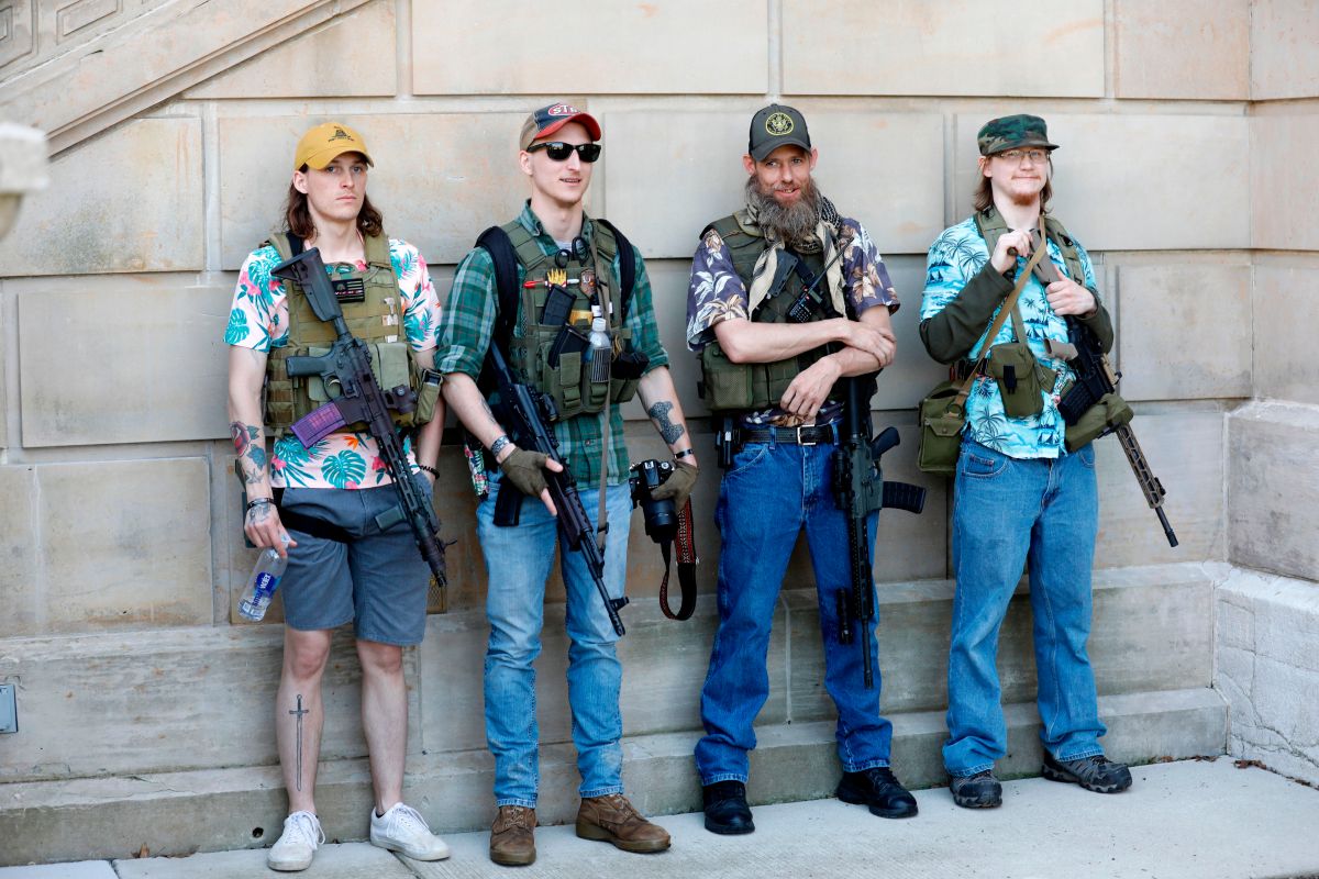 Armed protesters demonstrate during the Michigan Conservative Coalition organized "Operation Haircut" outside the Michigan State Capitol in Lansing, Michigan on May 20, 2020. - The group is protesting Michigan Governor Gretchen Whitmer's mandatory closure to curtail the coronavirus pandemic. The Hawaiian shirts are a kind of uniform for members of extremist groups "Boogaloo". (Photo by JEFF KOWALSKY / AFP) (Photo by JEFF KOWALSKY/AFP via Getty Images)