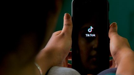 An Indian mobile user browses through the Chinese owned video-sharing 'Tik Tok' app on a smartphone in Bangalore on June 30, 2020. - TikTok on June 30 denied sharing information on Indian users with the Chinese government, after New Delhi banned the wildly popular app citing national security and privacy concerns. 