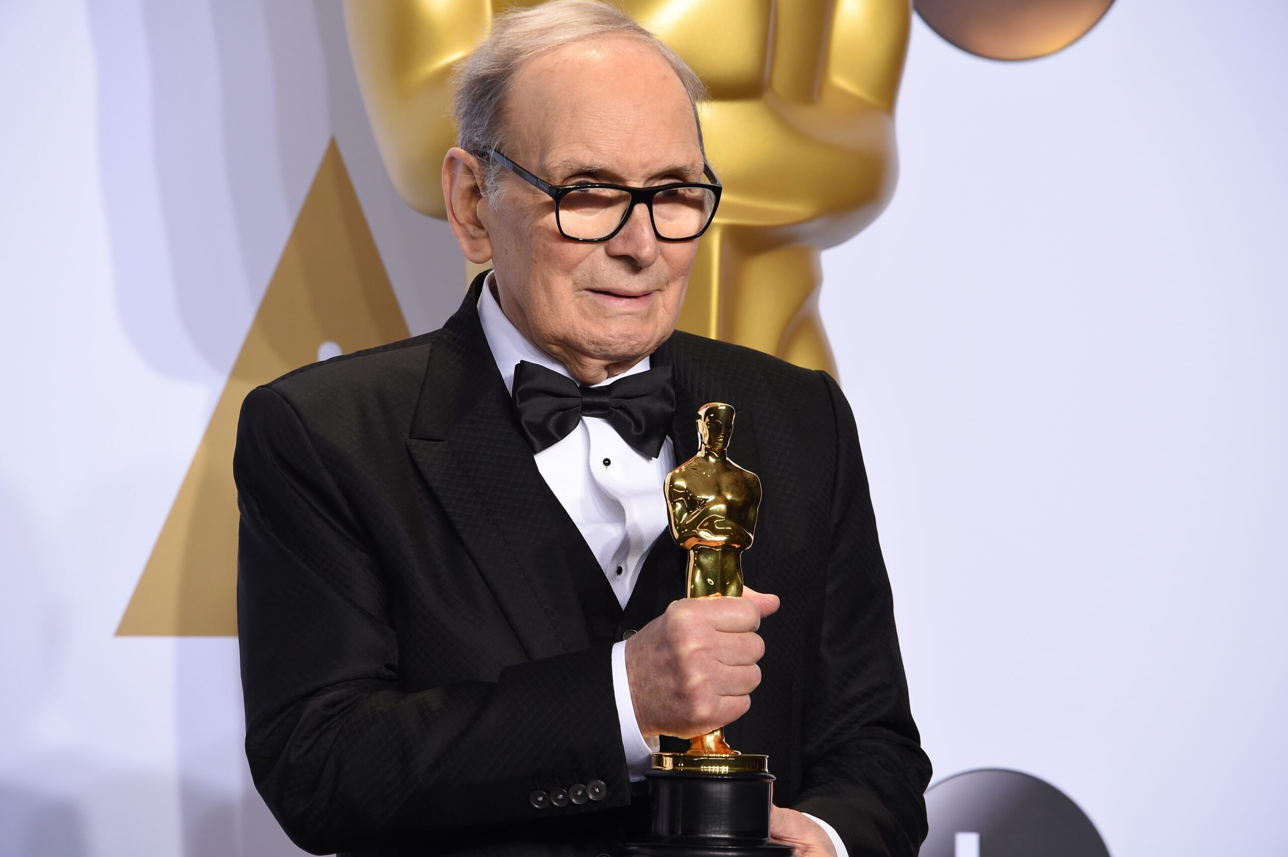 Composer Ennio Morricone poses with the Oscar for Best Original Score, "The Hateful Eight," in the press room during the 88th Oscars in Hollywood on February 28, 2016. (Photo by Robyn BECK / AFP) (Photo by ROBYN BECK/AFP via Getty Images)