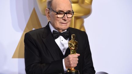 Composer Ennio Morricone poses with the Oscar for Best Original Score, 
