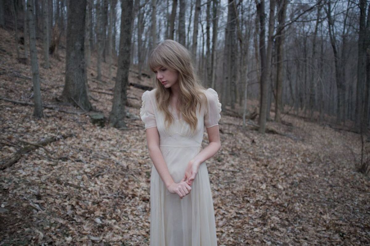 taylor swift looks sad in a forest