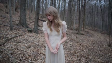 taylor swift looks sad in a forest