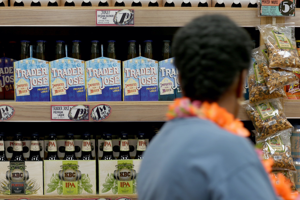 A Trader Joe's customer looks at Trader Jose branded beer."