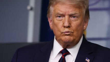 Donald Trump purses his lips during a coronavirus press briefing.