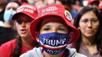 A young supporter wears a Trump 2020 mask at Trump's Tulsa rally.