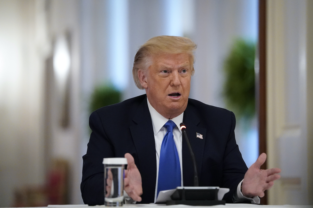 Donald Trump speaks and gestures in the White House.