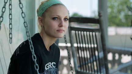 Daisy Coleman sits on her porch in a still from Audrie & Daisy.