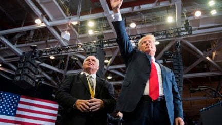 US President Donald Trump alongside radio talk show host Rush Limbaugh arrive at a Make America Great Again rally in Cape Girardeau, Missouri on November 5, 2018. (Photo by Jim WATSON / AFP) (Photo credit should read JIM WATSON/AFP via Getty Images)