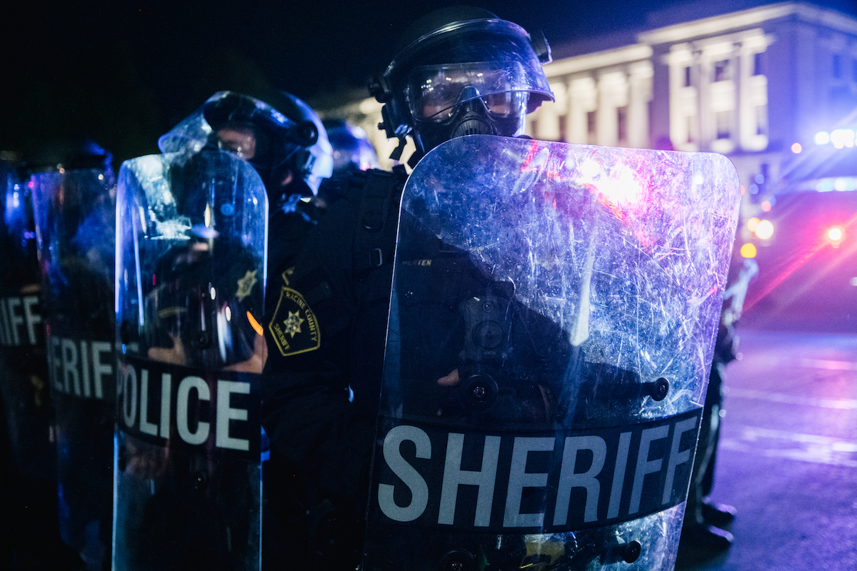 A row of police officers holding shields in Kenosha, Wisconsin.