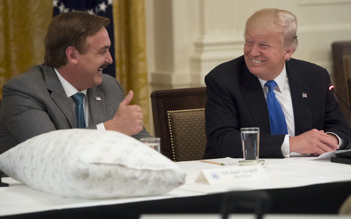 Donald Trump speaks alongside Mike Lindell (L), founder of My Pillow